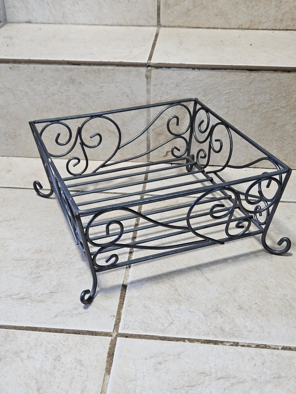 Black metal wire rack with decorative swirls #rustic #metalwork